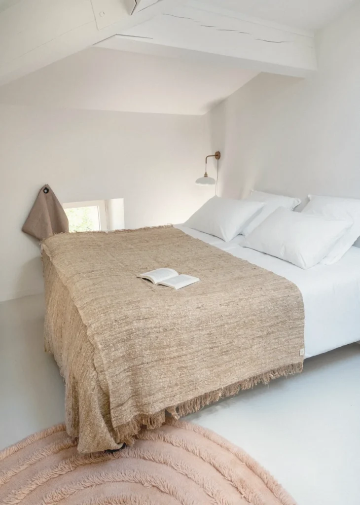 A guest room at Pantoufle Hôtel with an open book on the bed