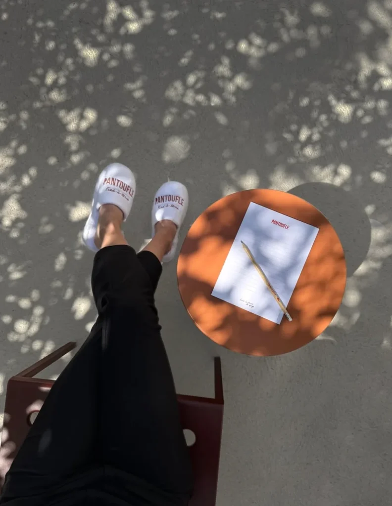 Pantoufle slippers beside an orange table